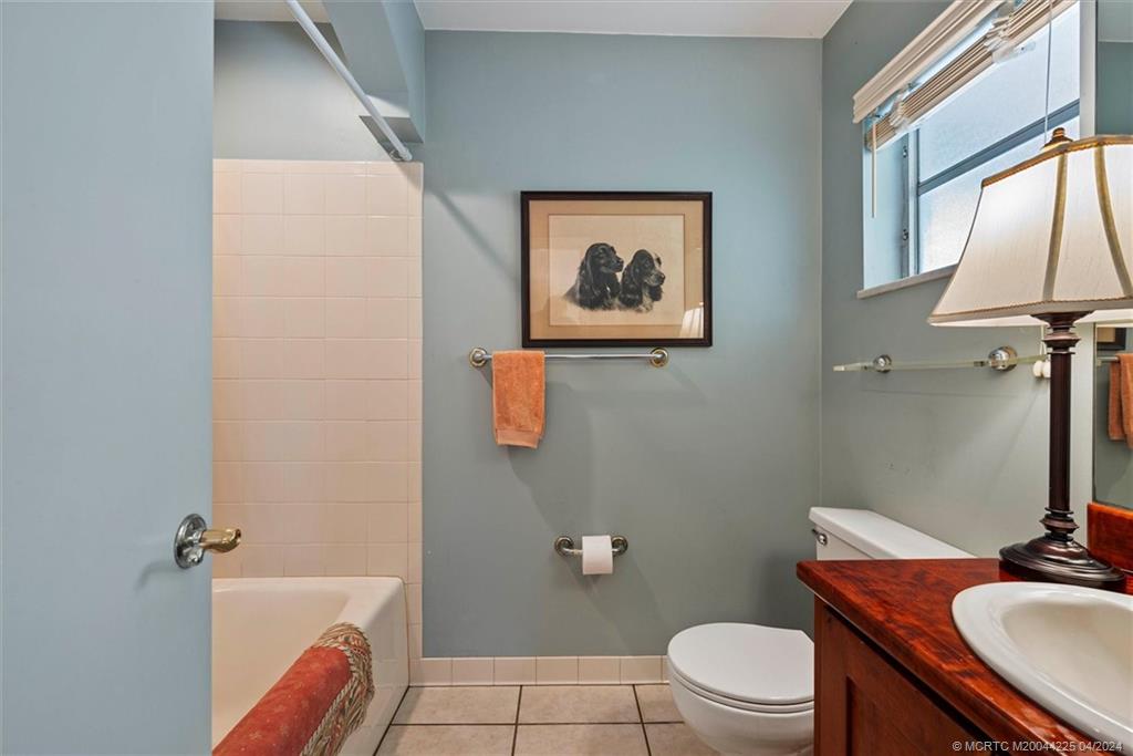 111 South Sewalls Point Road Stuart, FL 34996 - Photo 37 of 60 a bathroom with a granite countertop sink a toilet and a tub