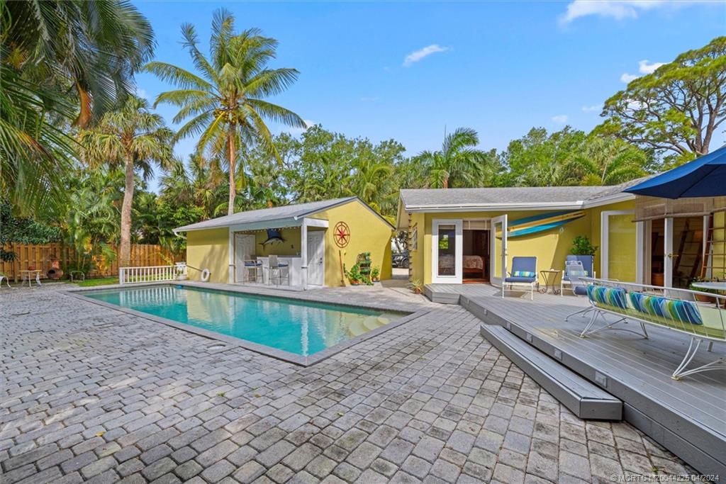 111 South Sewalls Point Road Stuart, FL 34996 - Photo 45 of 60 a view of a house with swimming pool and a porch with furniture