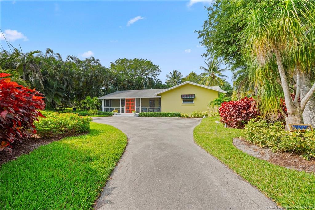 111 South Sewalls Point Road Stuart, FL 34996 - Photo 9 of 60 a front view of a house with garden