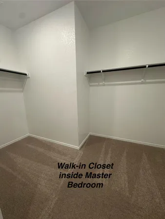 a view of a room with wooden floor and cabinet