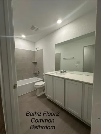 a bathroom with a sink a toilet and mirror