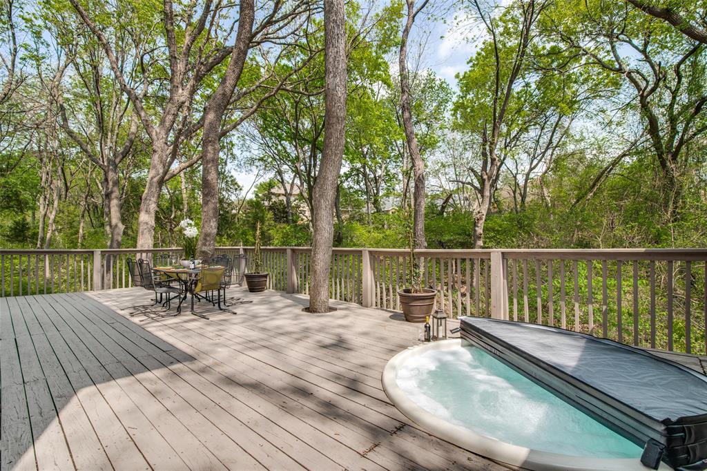 a view of a balcony with wooden floor and fence