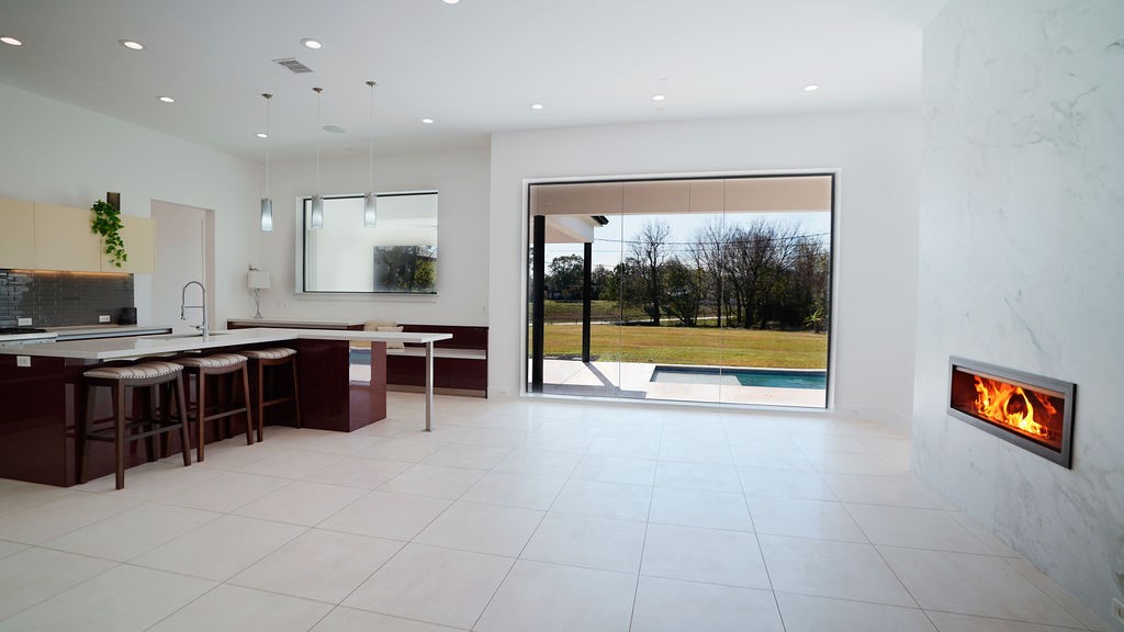 3308 North MacGregor Way Houston, TX 77004 - Photo 17 of 46 Breakfast area with a wall of windows overlooking the pool and backyard