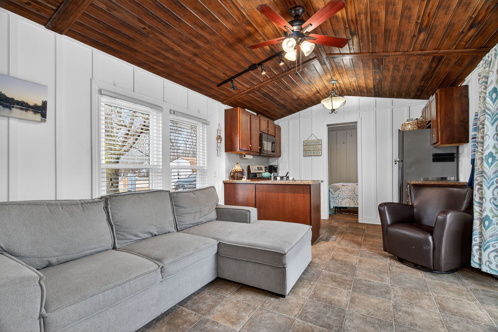 95 Dinosaur Road Wilmington, IL 60481 - Photo 3 of 54 a living room with furniture a ceiling fan a flat screen tv and kitchen view