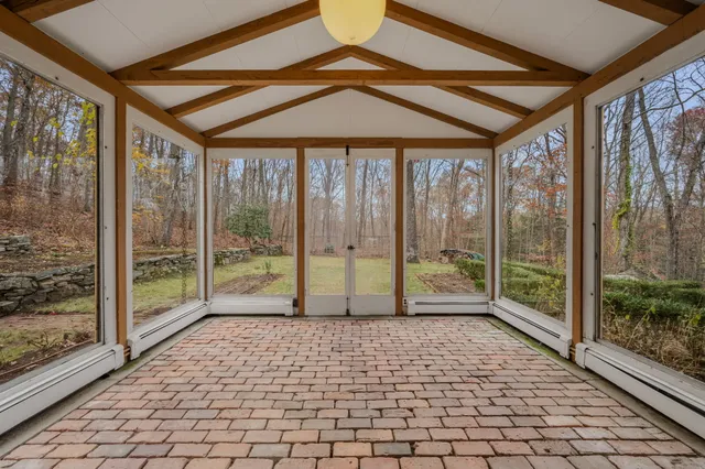 a view of empty room with wooden floor and floor to ceiling window