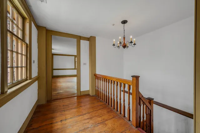 a view of empty room with wooden floor and cabinet