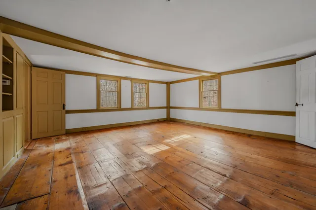 a bathroom with a bathtub a sink a mirror and a window