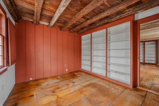 a view of an entryway with wooden floor and door