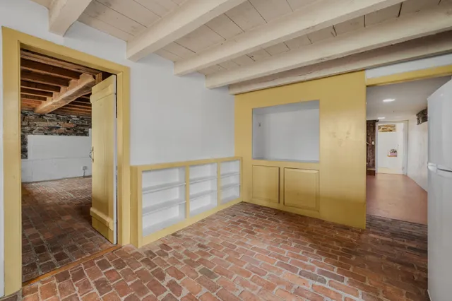 a front view of a house with a tree