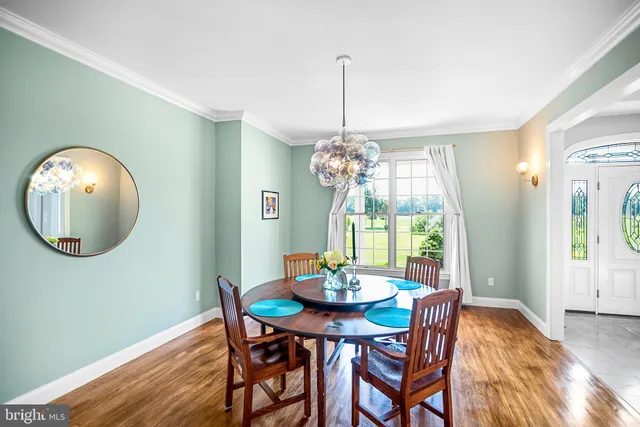 a view of a dining room with a table and chairs
