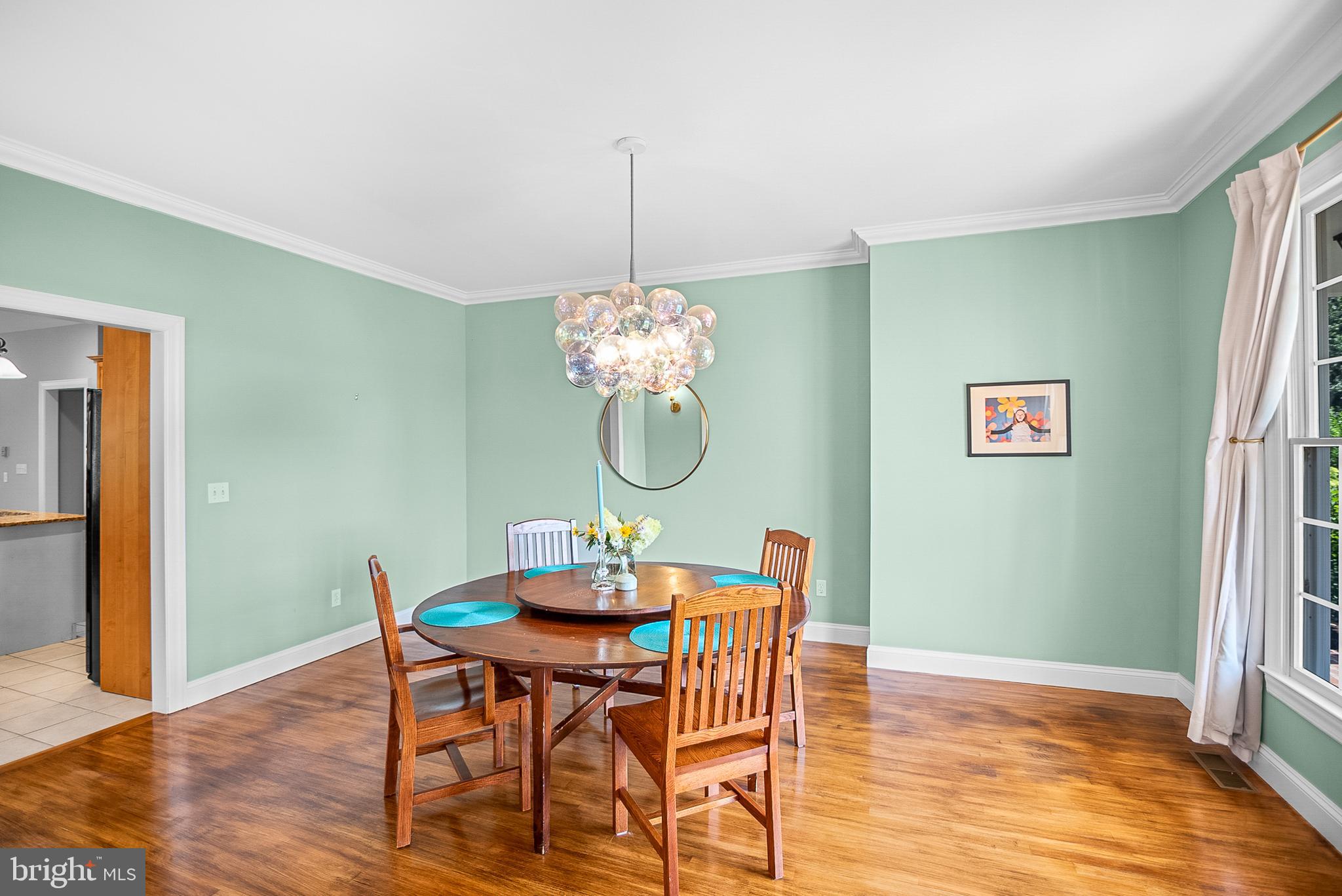 26604 East Bonfield Road Oxford, MD 21654 - Photo 12 of 44 a view of a dining room with furniture wooden floor and a chandelier