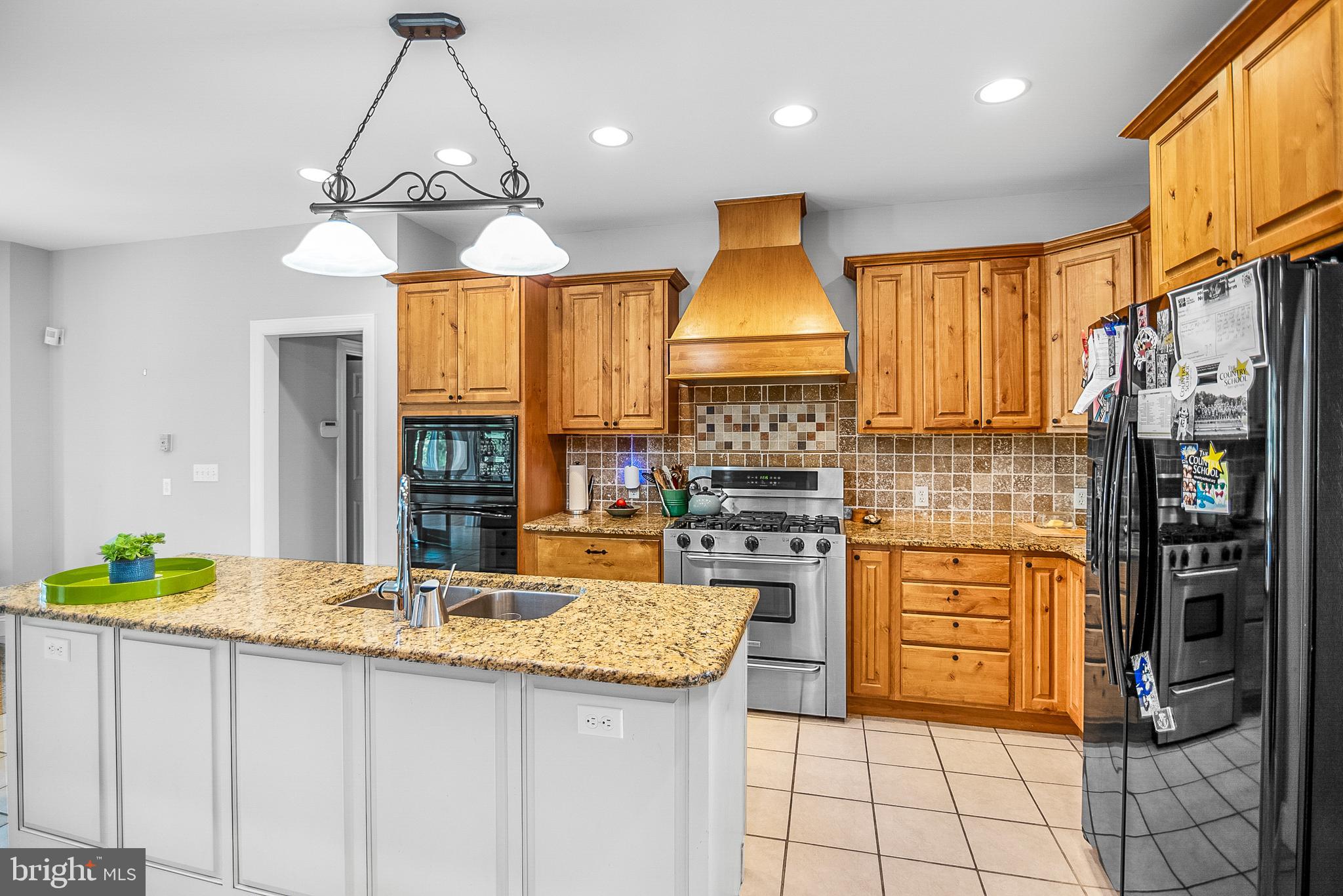 26604 East Bonfield Road Oxford, MD 21654 - Photo 13 of 44 a kitchen with stainless steel appliances granite countertop a stove a sink and a refrigerator