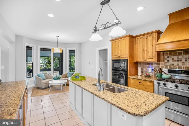 a large kitchen with kitchen island a large counter space windows and appliances
