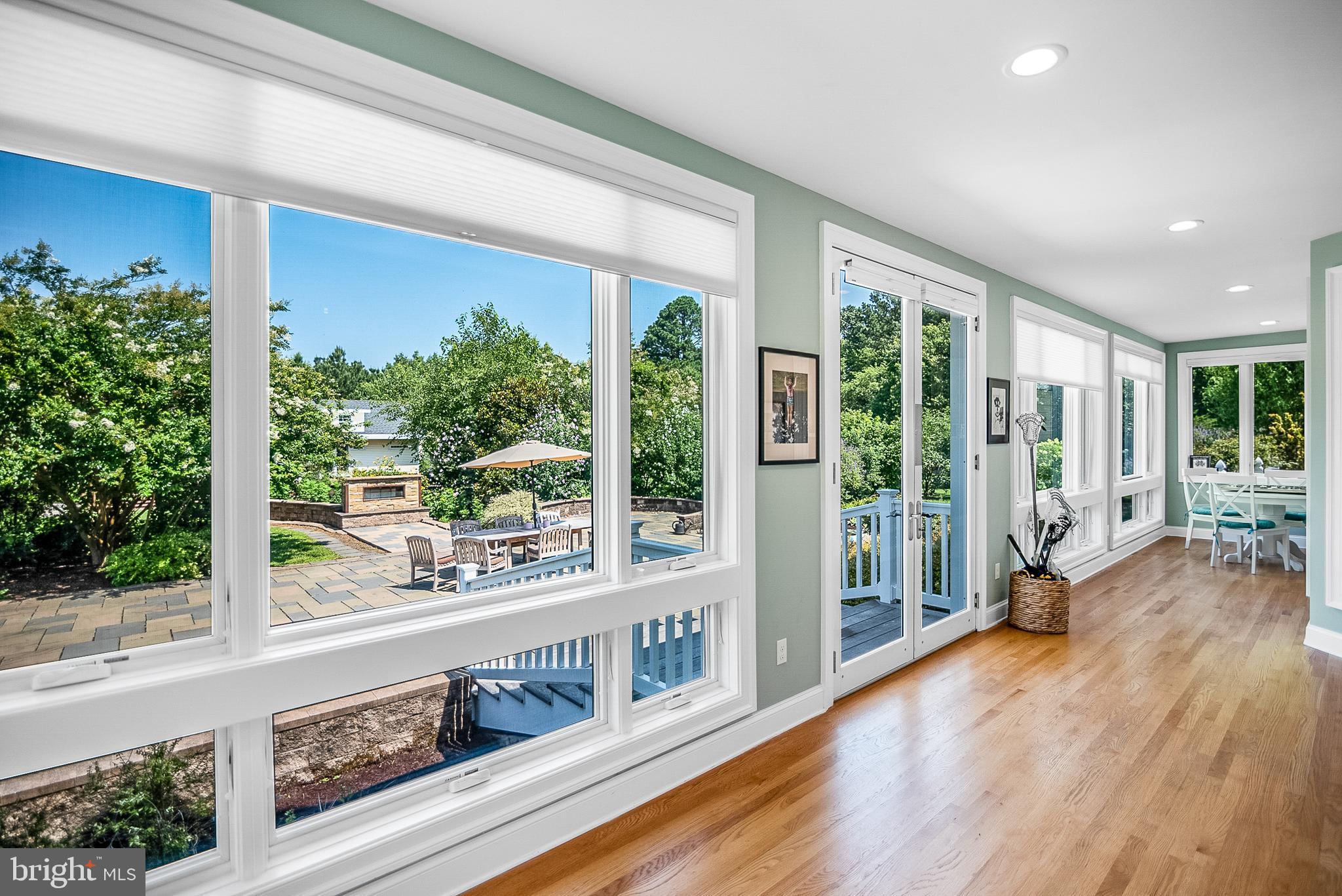 26604 East Bonfield Road Oxford, MD 21654 - Photo 20 of 44 a living room with large windows and wooden floor