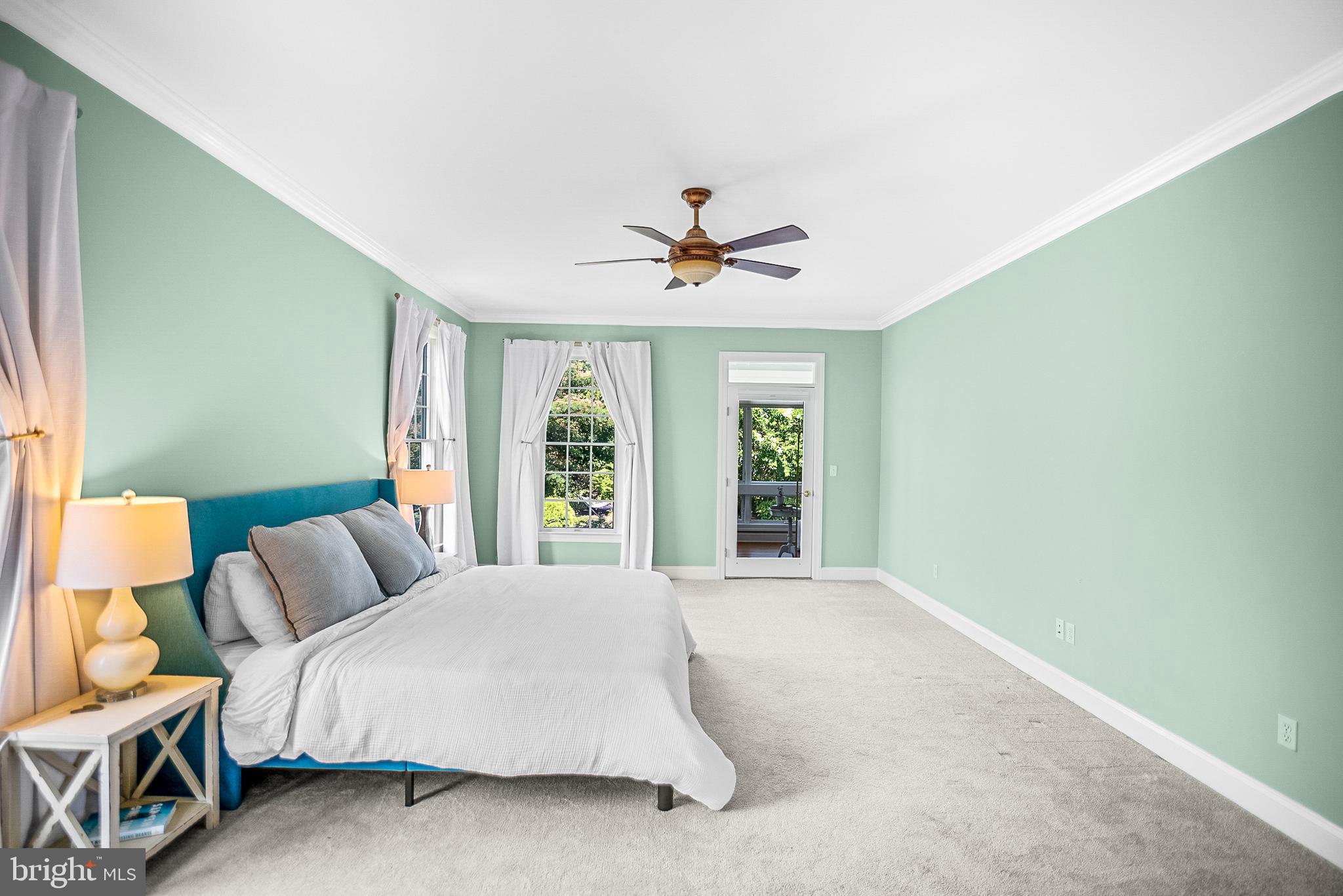 26604 East Bonfield Road Oxford, MD 21654 - Photo 22 of 44 a spacious bedroom with a bed and a large window