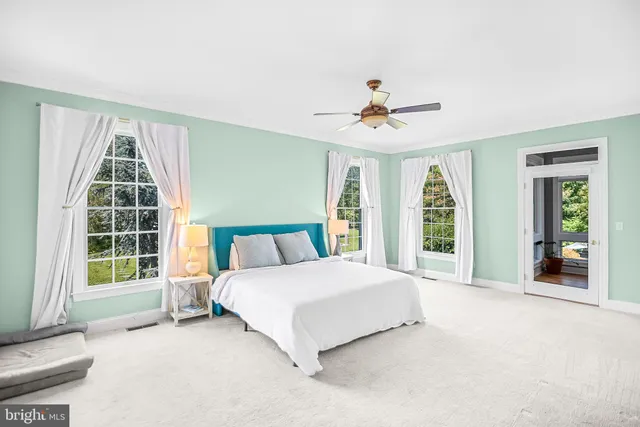 a spacious bedroom with a large bed and a large window