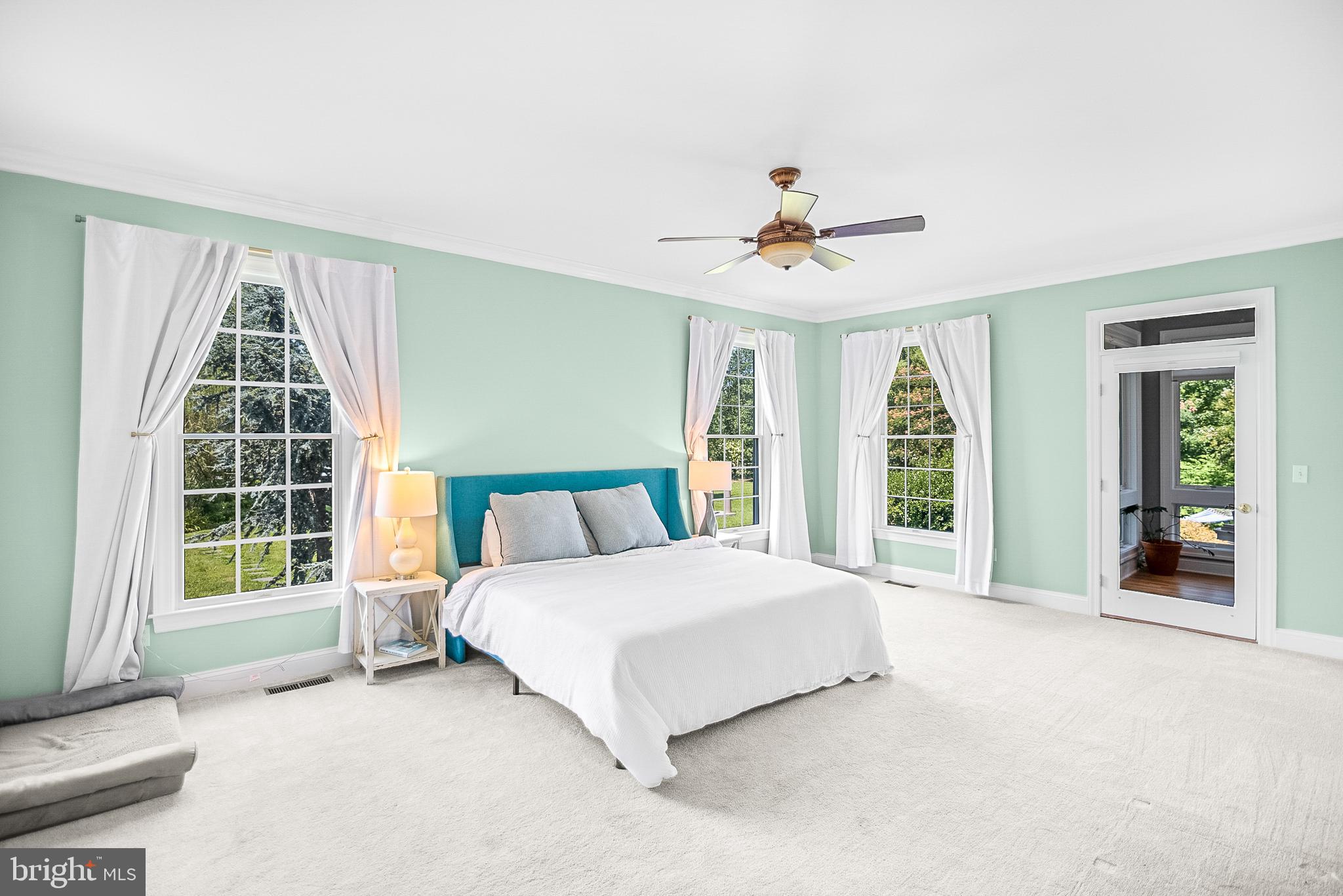 26604 East Bonfield Road Oxford, MD 21654 - Photo 23 of 44 a spacious bedroom with a large bed and a large window