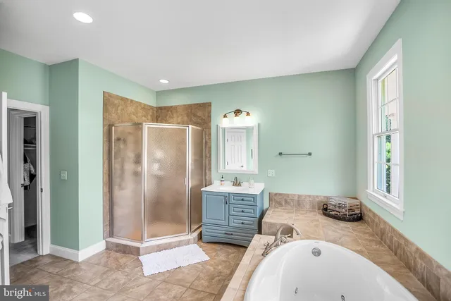 a bathroom with a granite countertop sink a mirror and shower