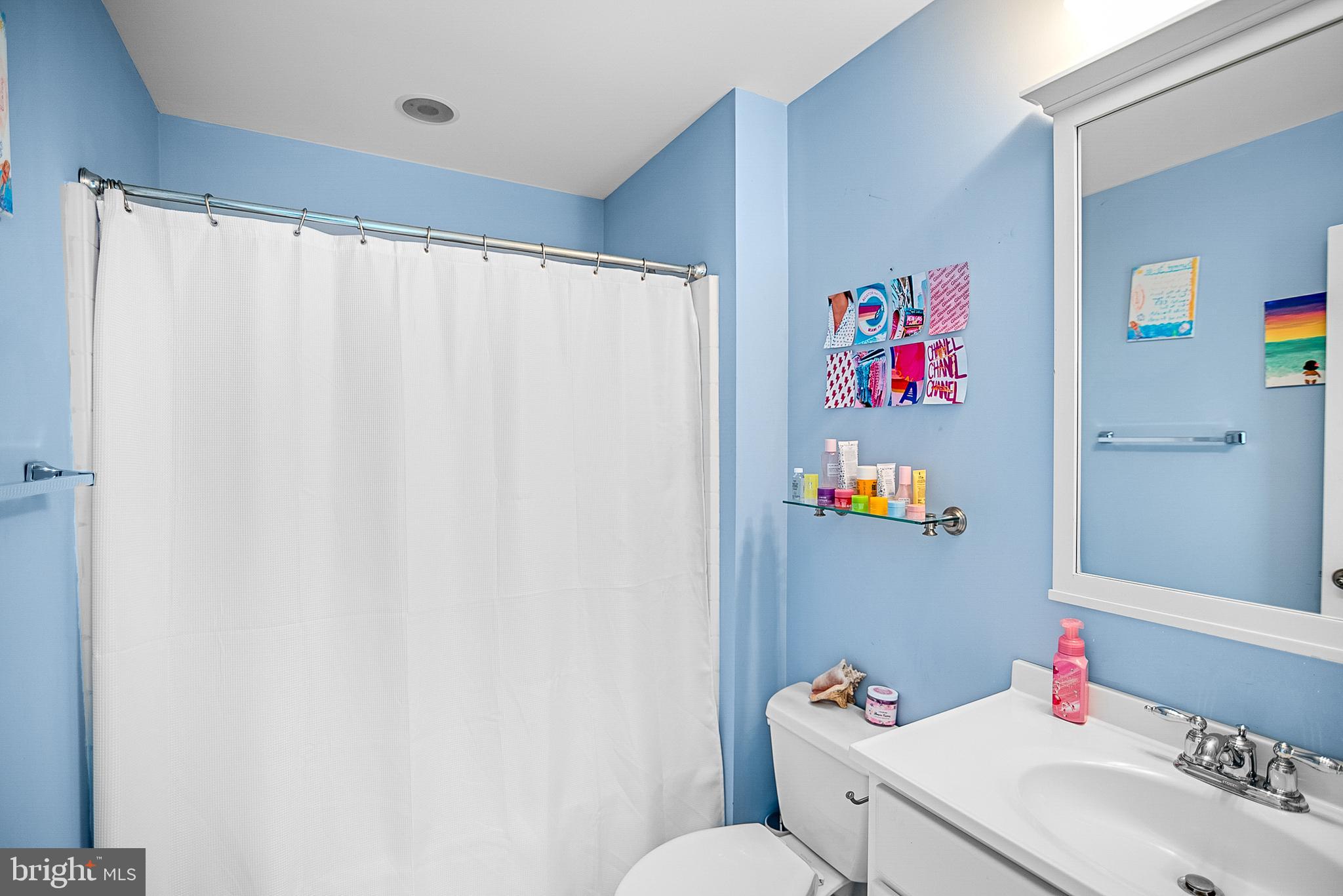 26604 East Bonfield Road Oxford, MD 21654 - Photo 28 of 44 a bathroom with a sink vanity mirror and toilet