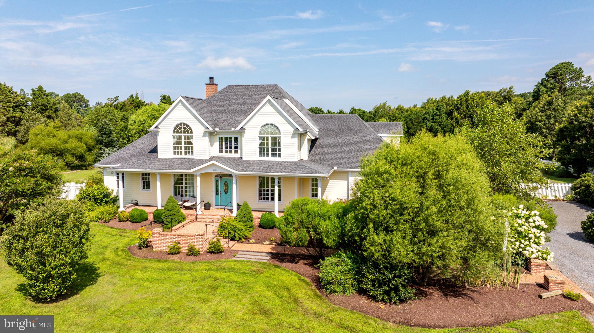 26604 East Bonfield Road Oxford, MD 21654 - Photo 3 of 44 a front view of a house with a garden