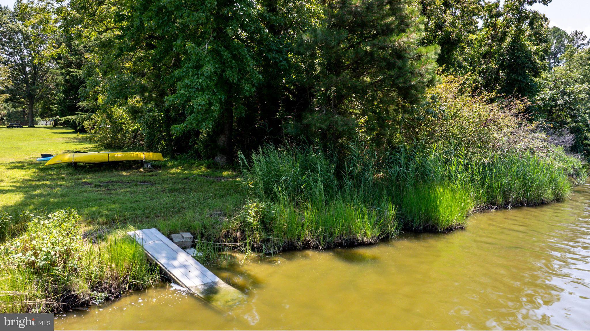 26604 East Bonfield Road Oxford, MD 21654 - Photo 31 of 44 a view of a swimming pool with a garden