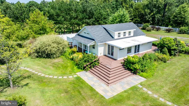 a aerial view of a house with swimming pool garden and patio