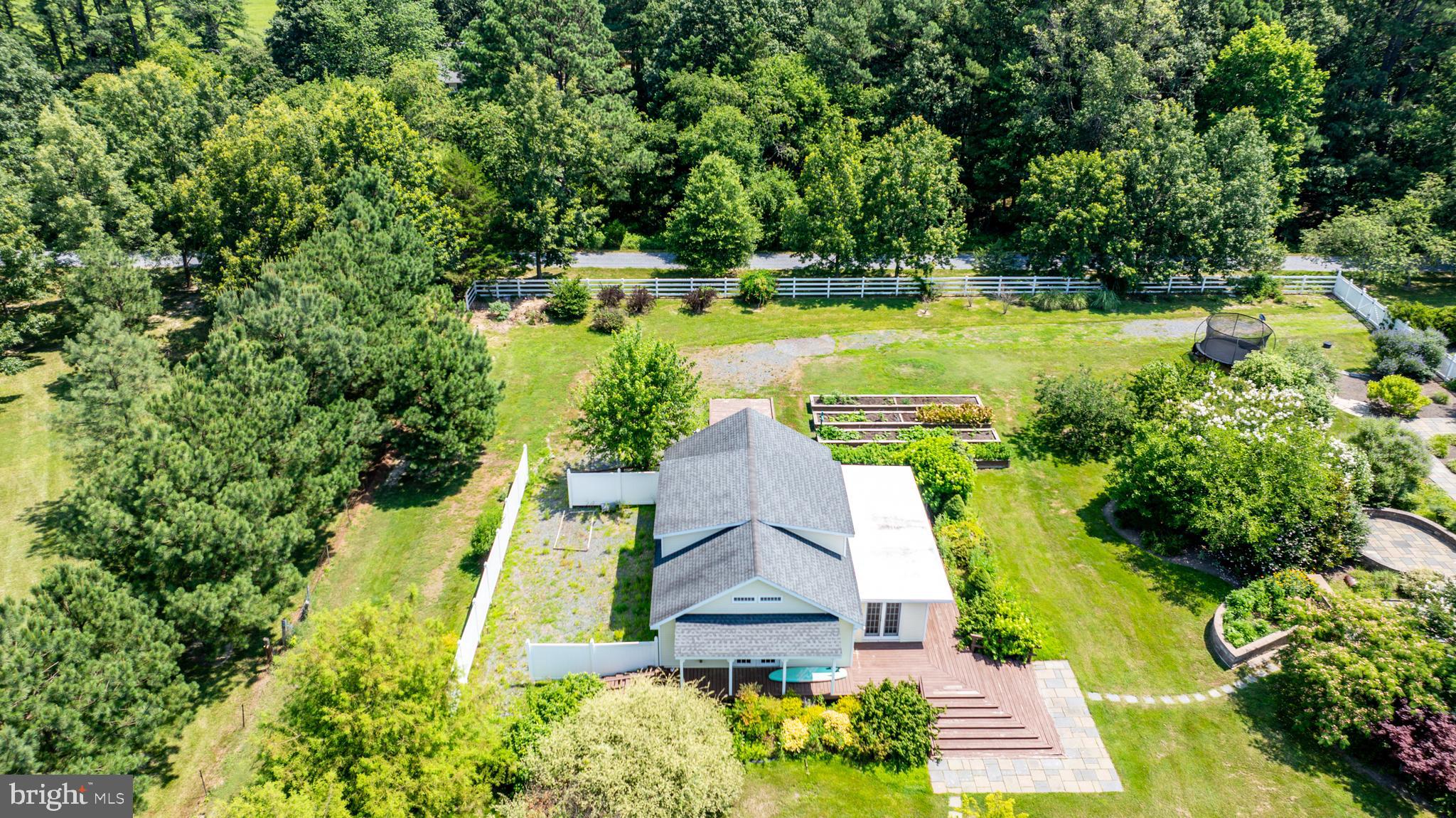 26604 East Bonfield Road Oxford, MD 21654 - Photo 40 of 44 an aerial view of a house with swimming pool a yard and lake view