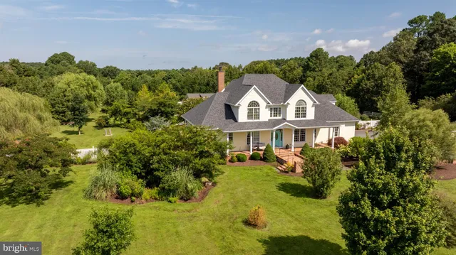 a front view of a house with a yard and potted plants