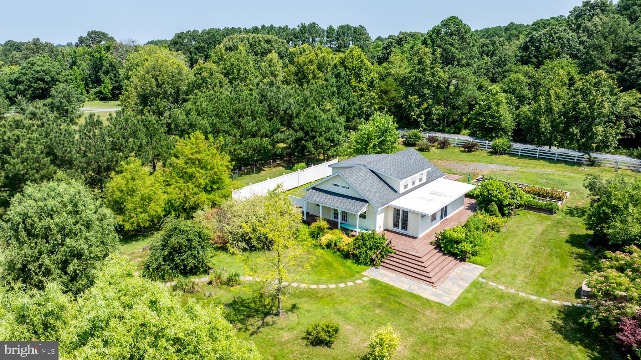 26604 East Bonfield Road Oxford, MD 21654 - Photo 41 of 44 an aerial view of a house with swimming pool and garden