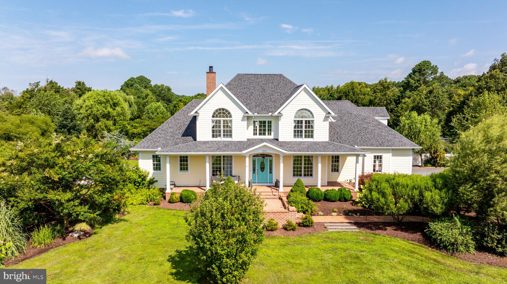 26604 East Bonfield Road Oxford, MD 21654 - Photo 5 of 44 a front view of a house with a yard and potted plants