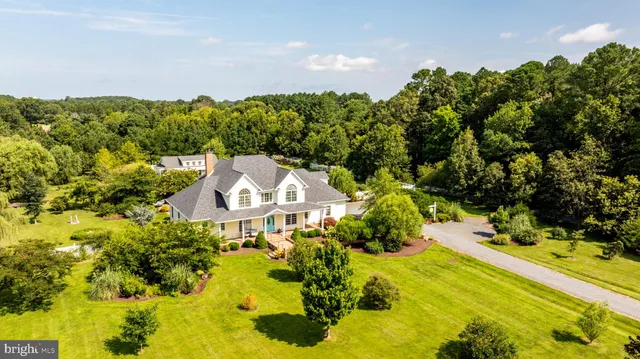 a view of a house with a yard and sitting area