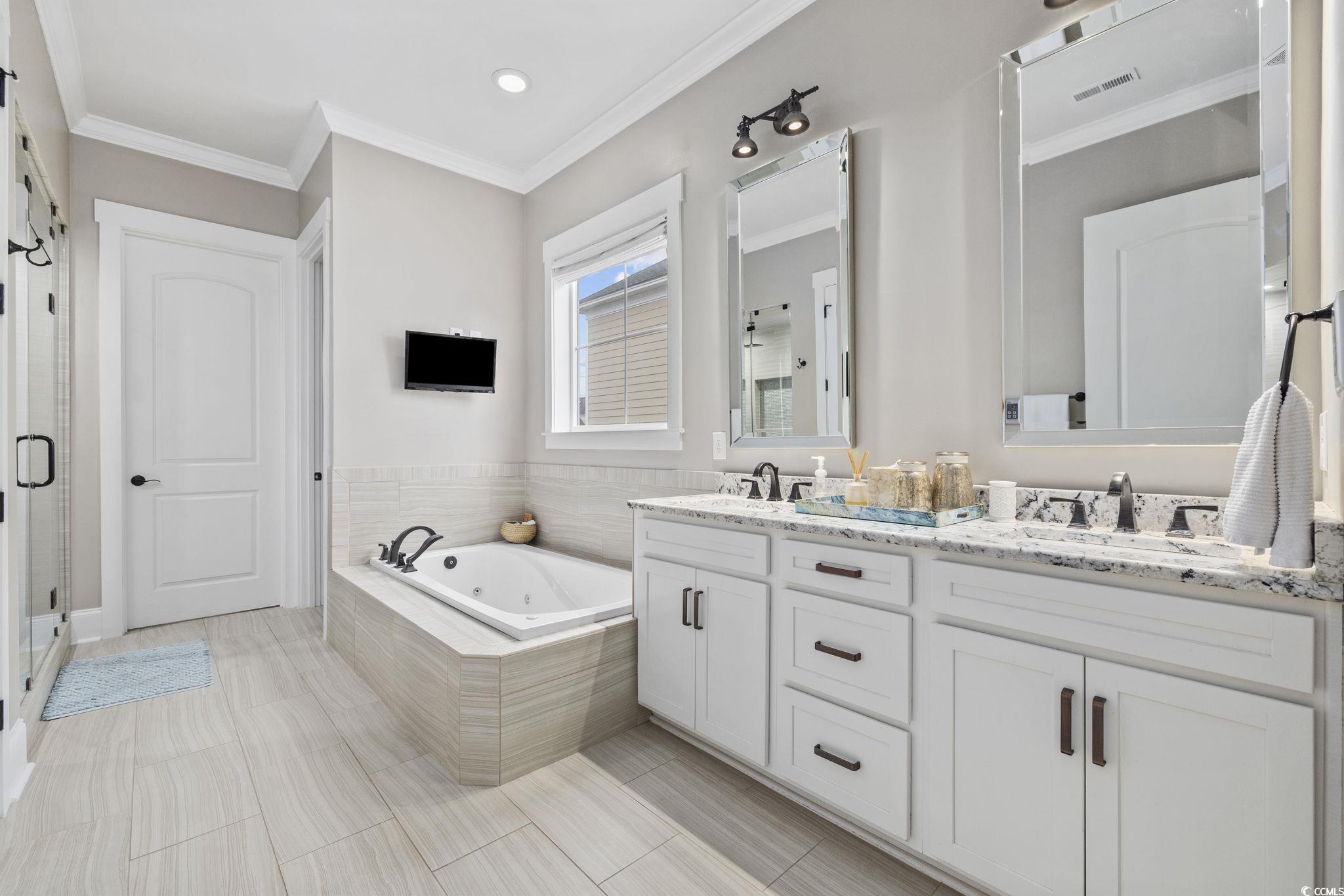 636 North Creekside Drive Murrells Inlet, SC 29576 - Photo 12 of 40 Full bath featuring a whirlpool tub, double vanity, ornamental molding, and a shower stall