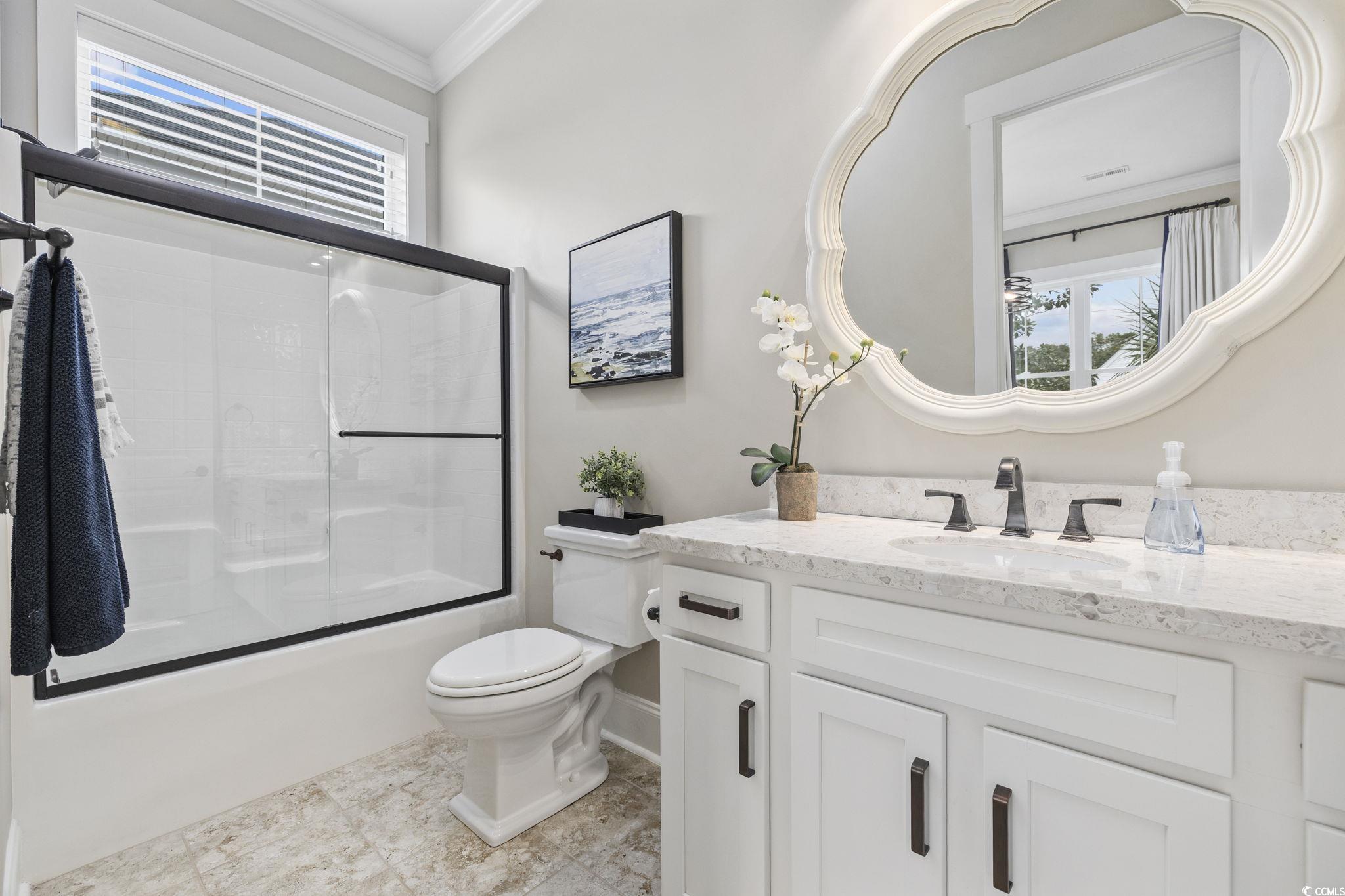 636 North Creekside Drive Murrells Inlet, SC 29576 - Photo 20 of 40 Bathroom with healthy amount of natural light, ornamental molding, shower / bath combination with glass door, and vanity