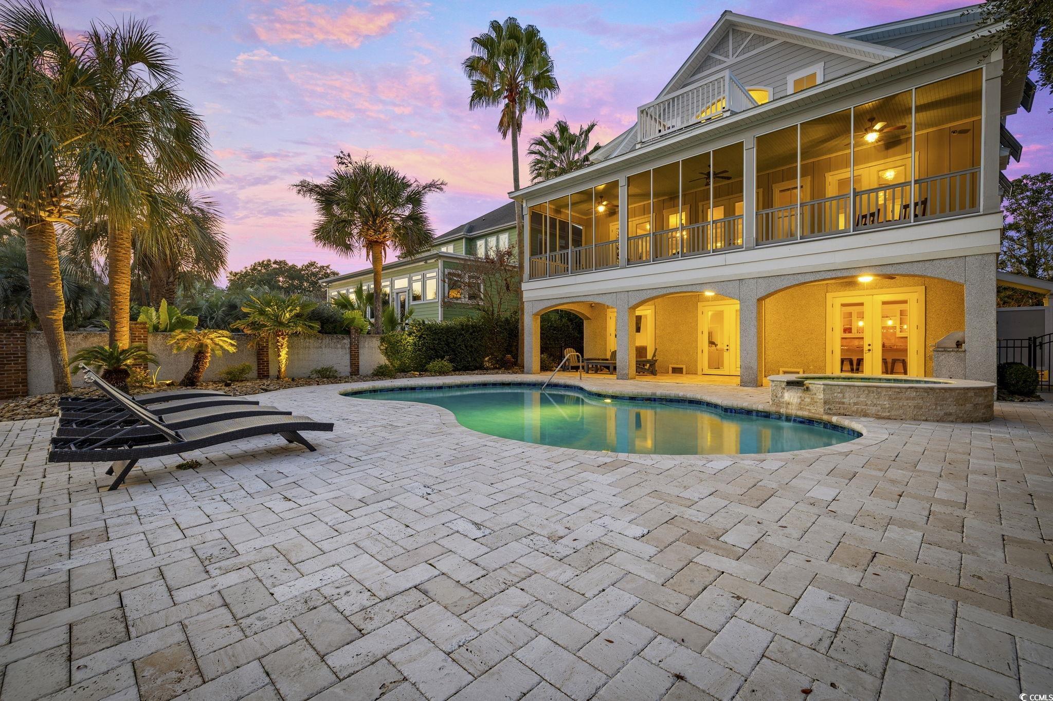 636 North Creekside Drive Murrells Inlet, SC 29576 - Photo 37 of 40 Pool at dusk with a patio area, a balcony, and a pool with connected hot tub