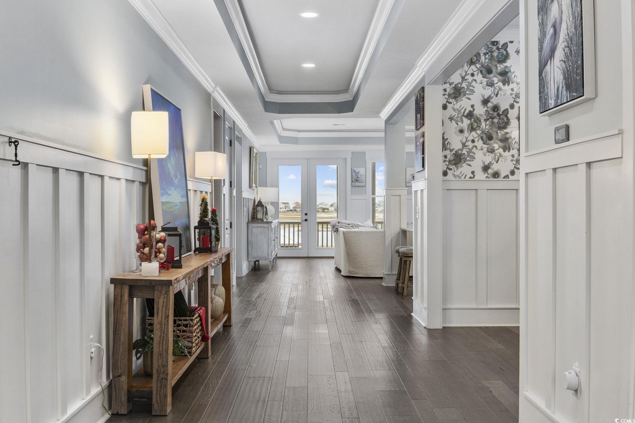 636 North Creekside Drive Murrells Inlet, SC 29576 - Photo 4 of 40 Hall featuring a decorative wall, french doors, a raised ceiling, dark wood finished floors, and a wainscoted wall
