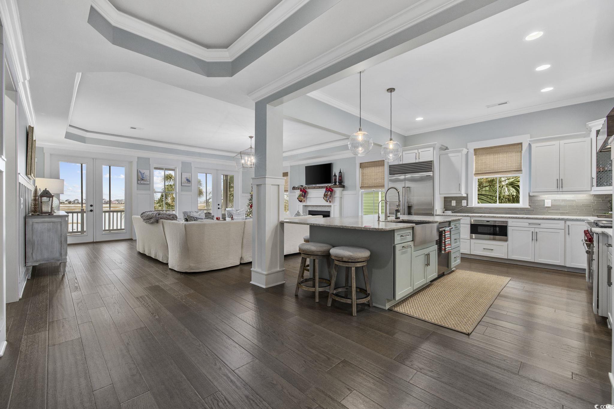 636 North Creekside Drive Murrells Inlet, SC 29576 - Photo 40 of 40 Kitchen with open floor plan, a kitchen breakfast bar, pendant lighting, french doors, and an island with sink