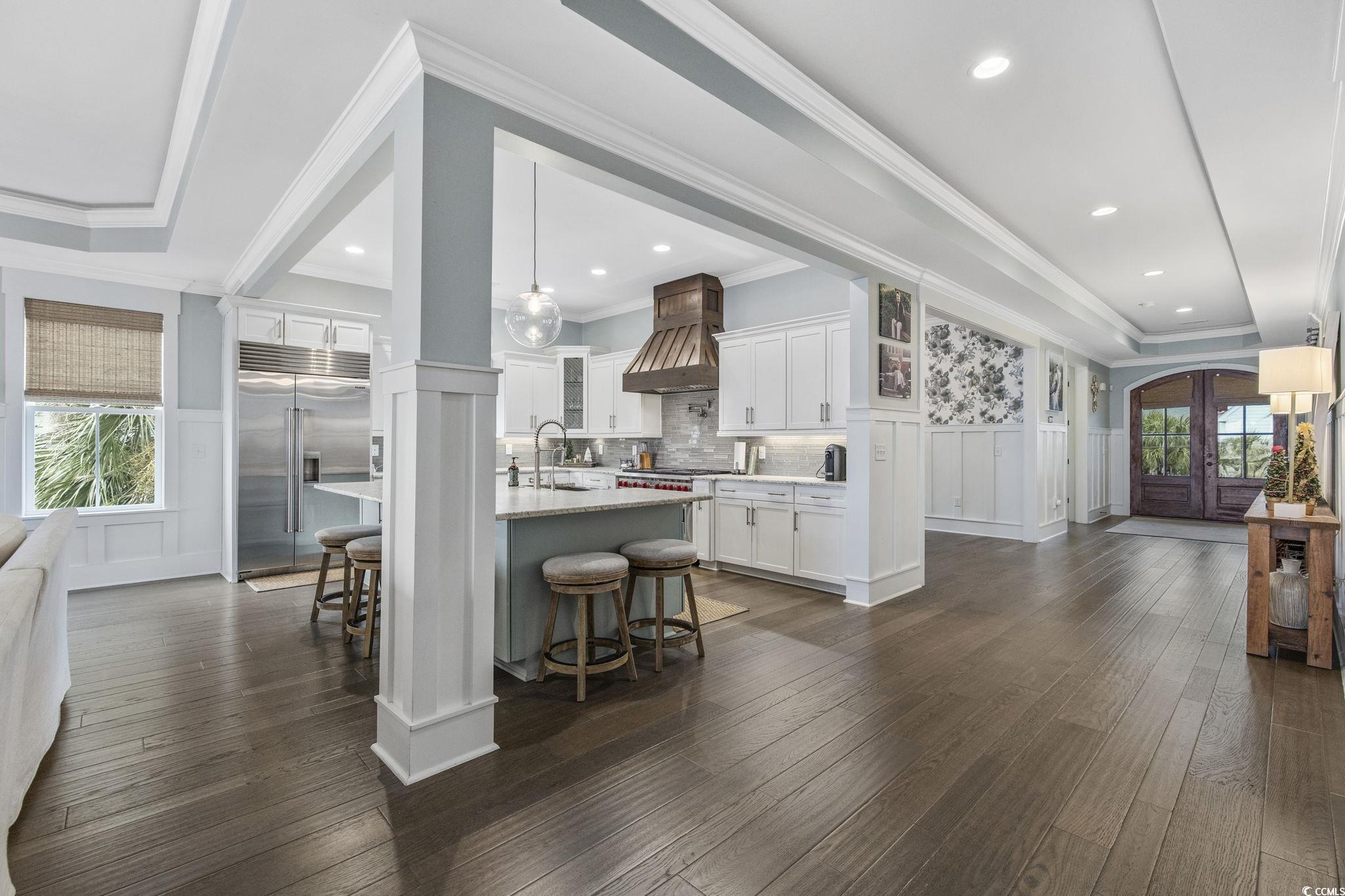 636 North Creekside Drive Murrells Inlet, SC 29576 - Photo 7 of 40 Kitchen featuring a decorative wall, plenty of natural light, a wainscoted wall, a breakfast bar area, and ornamental molding
