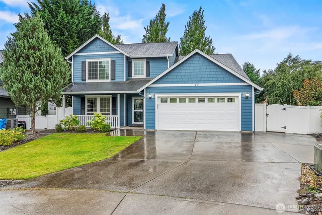 a view of a house with a yard and garage