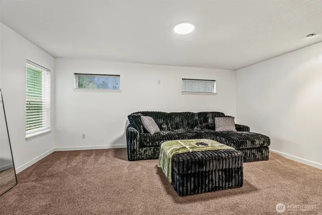 a spacious bedroom with a bed and a window