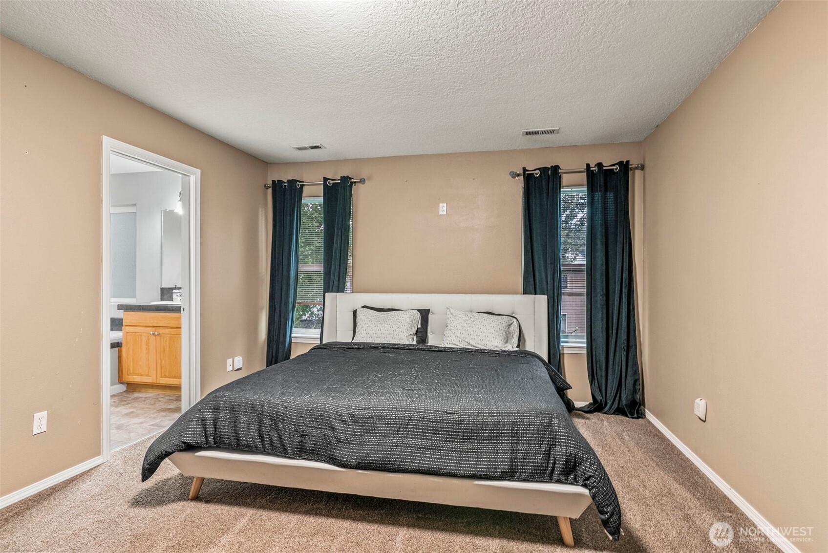 70 Crown Point Road Longview, WA 98632 - Photo 21 of 33 a bedroom with a large bed and dresser with mirror