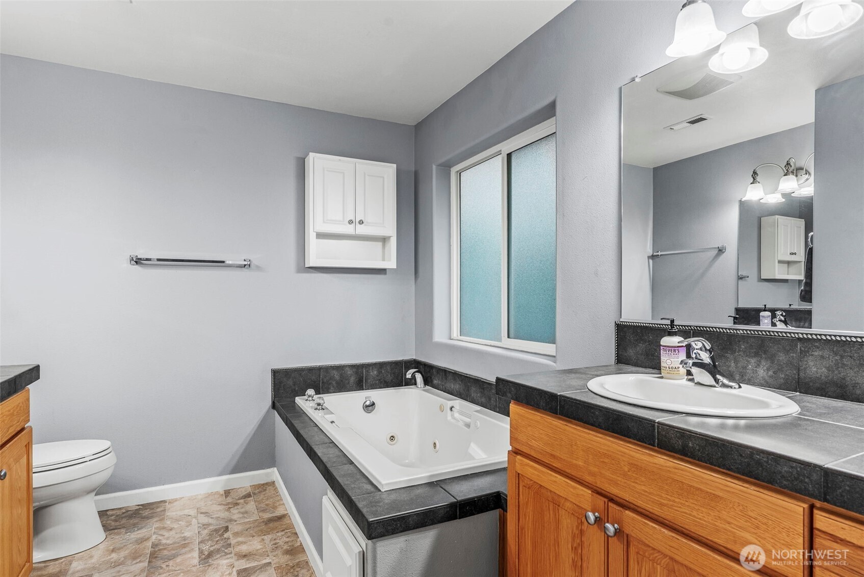 70 Crown Point Road Longview, WA 98632 - Photo 23 of 33 a bathroom with a sink a toilet and a mirror