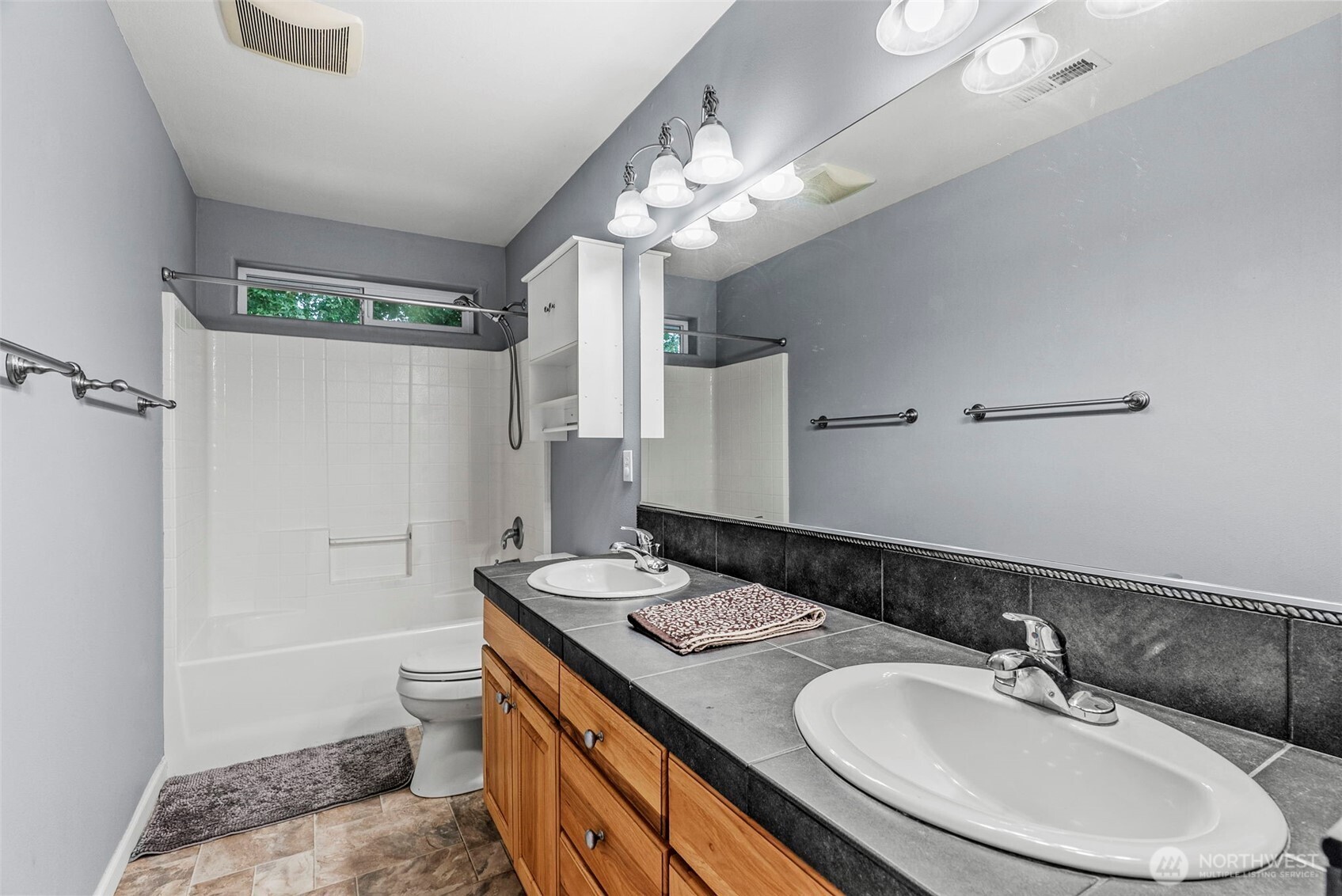 70 Crown Point Road Longview, WA 98632 - Photo 25 of 33 a bathroom with a sink a toilet a mirror and shower