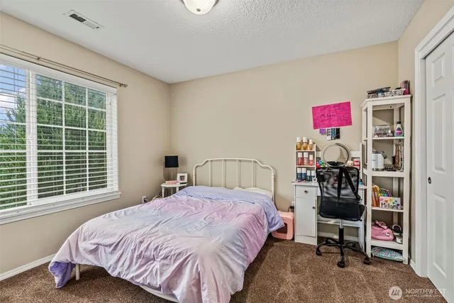 a bedroom with a bed and a chair