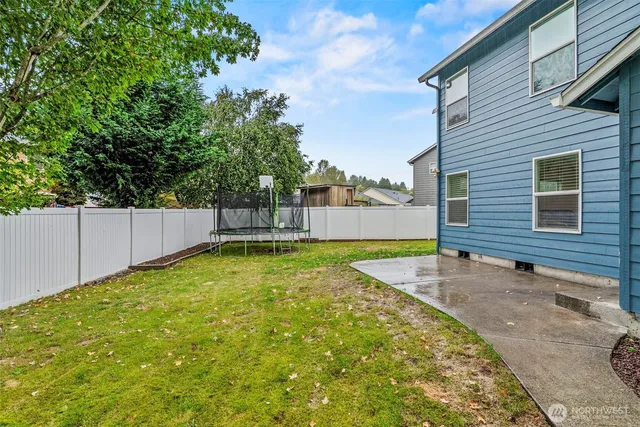 a backyard of a house with table and chairs