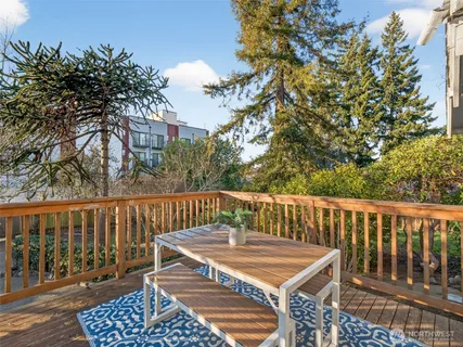 a view of balcony with wooden floor and fence