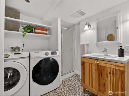 a utility room with sink dryer and washer