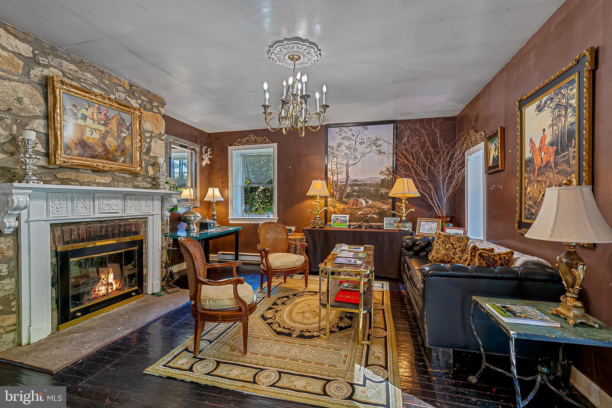 1610 Delaplane Grade Road Upperville, VA 20184 - Photo 30 of 123 a living room with furniture a fireplace and a chandelier