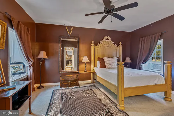 a view of hallway with furniture and a rug