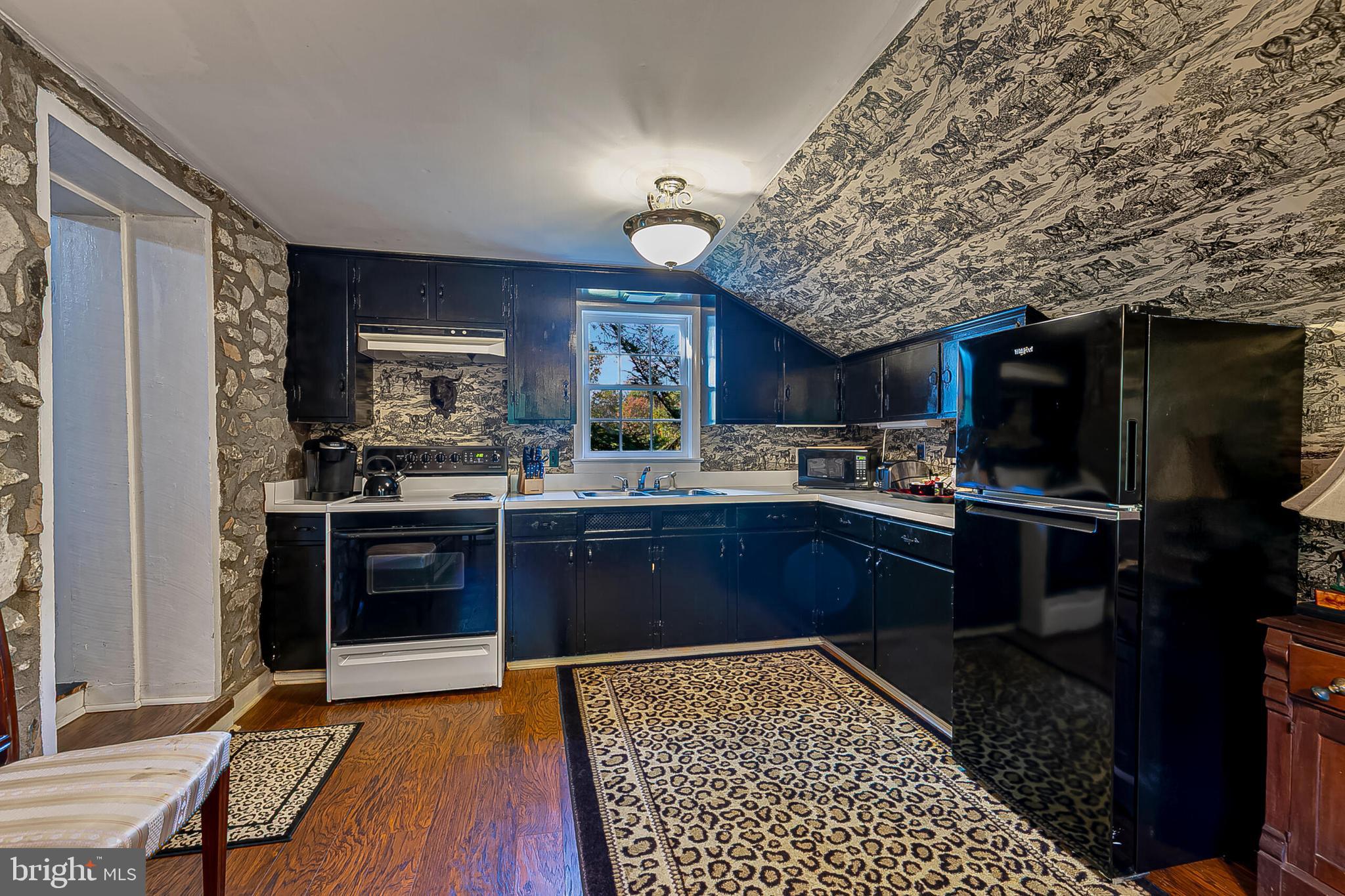 1610 Delaplane Grade Road Upperville, VA 20184 - Photo 33 of 123 a kitchen with stainless steel appliances kitchen island granite countertop a refrigerator stove and oven