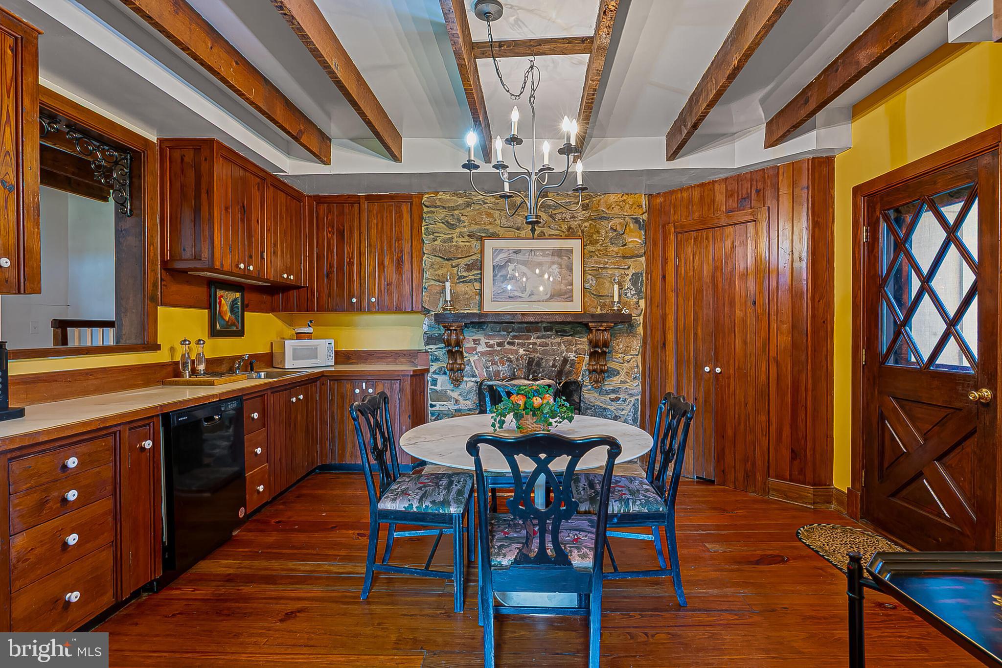 1610 Delaplane Grade Road Upperville, VA 20184 - Photo 36 of 123 a kitchen with stainless steel appliances granite countertop furniture wooden floor a dining table and chairs